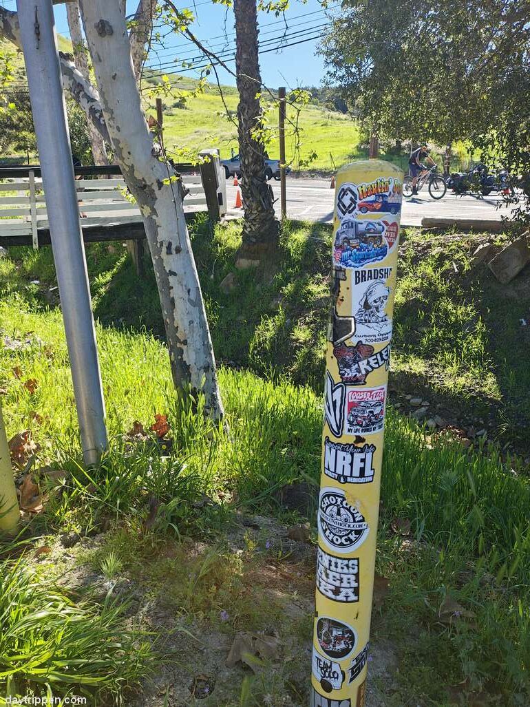 Stickers covering a pole at Cooks Stickers covering a pole at Cooks